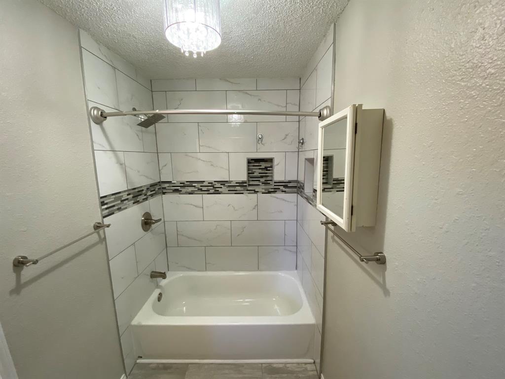 134 Main Place Euless, TX 76040 - Photo 13 of 25 a bathroom with a bathtub and a shower