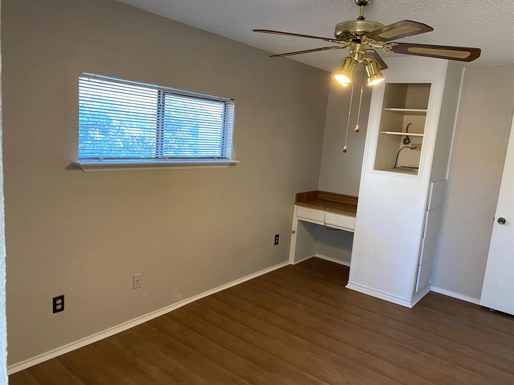 134 Main Place Euless, TX 76040 - Photo 15 of 25 a view of empty room with wooden floor and fan