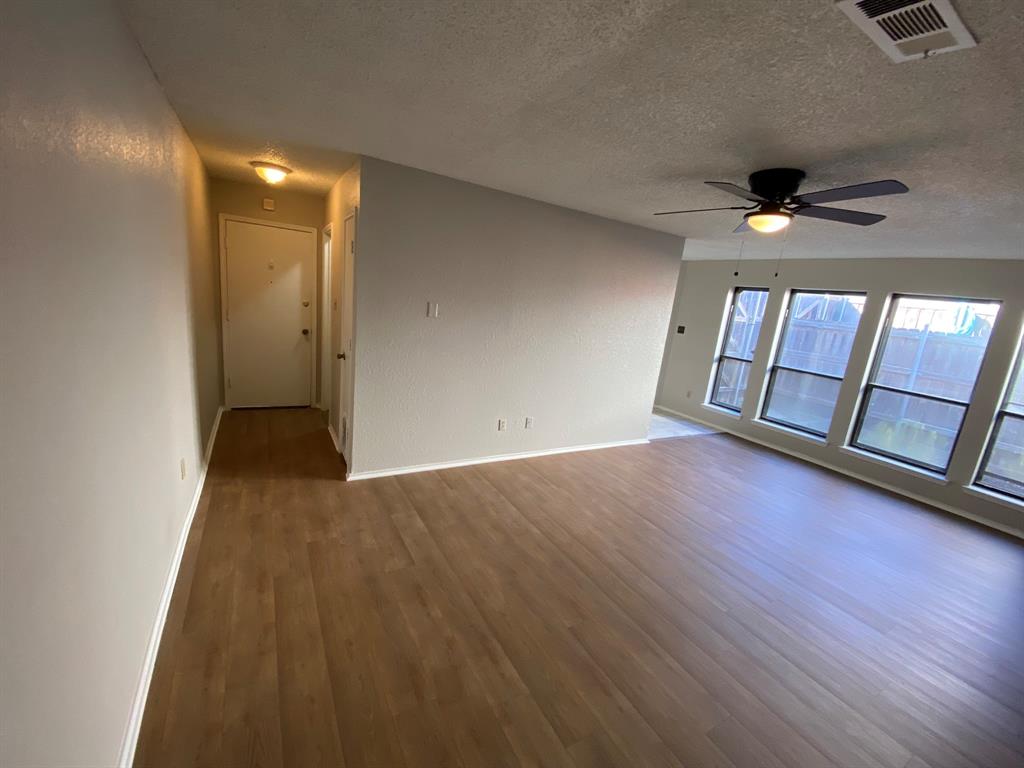 134 Main Place Euless, TX 76040 - Photo 4 of 25 wooden floor in an empty room with a window
