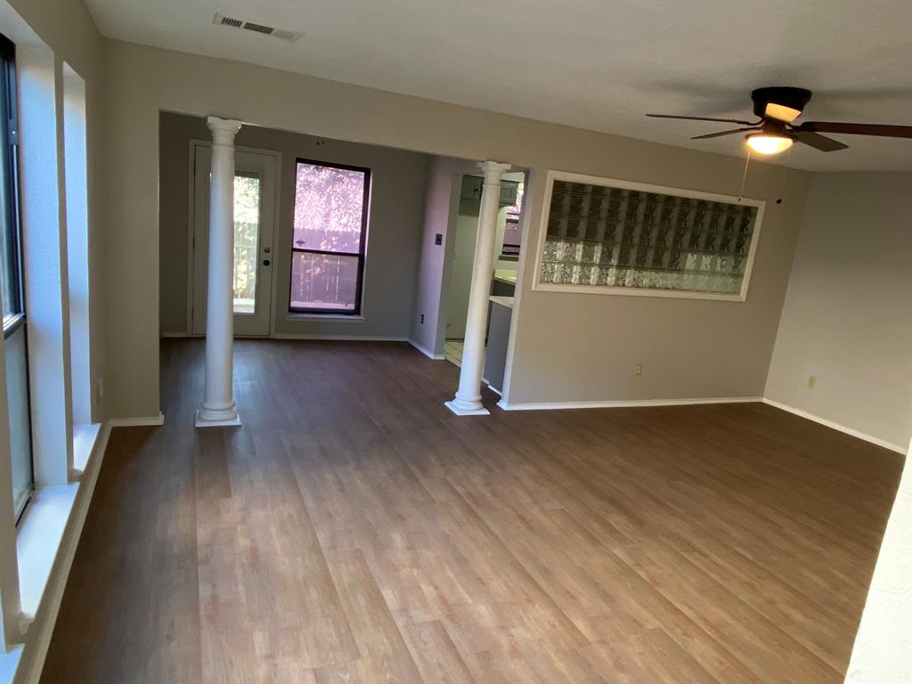 134 Main Place Euless, TX 76040 - Photo 5 of 25 wooden floor in an empty room with a window