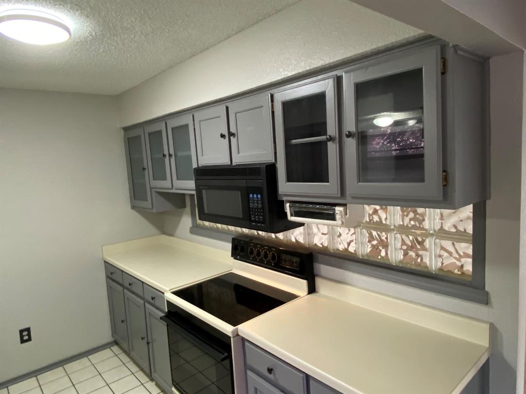 134 Main Place Euless, TX 76040 - Photo 7 of 25 a kitchen with stainless steel appliances a stove a microwave and a hard wood floors