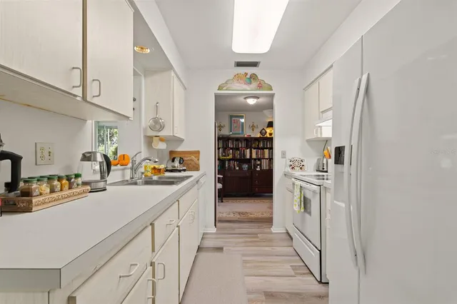 a kitchen with stainless steel appliances a sink and a refrigerator