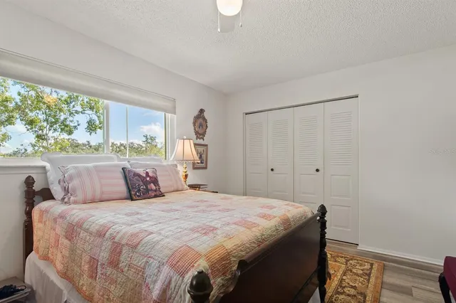 a bedroom with a large bed and a window