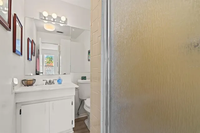 a bathroom with a sink vanity and a mirror