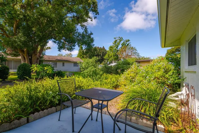 a view of a chairs and table in the patio