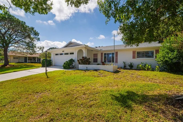 a view of a house with swimming pool and porch