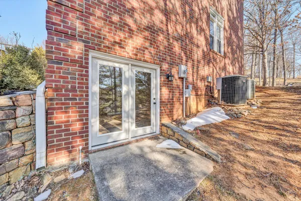 a view of a chair and tables in the patio