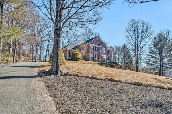 a view of a balcony with wooden floor and fence