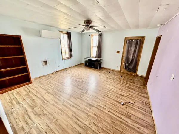 a view of a room with wooden floor and stairs