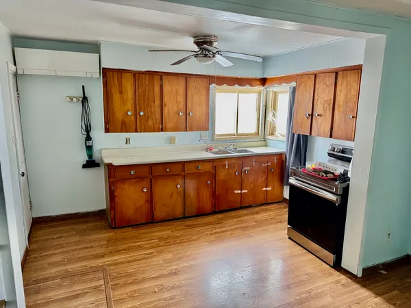 a kitchen with stainless steel appliances granite countertop a stove a sink and a refrigerator