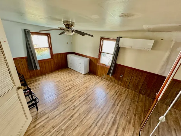 a view of a hallway with furniture and a mirror
