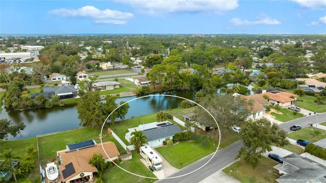 an aerial view of residential houses with outdoor space and swimming pool