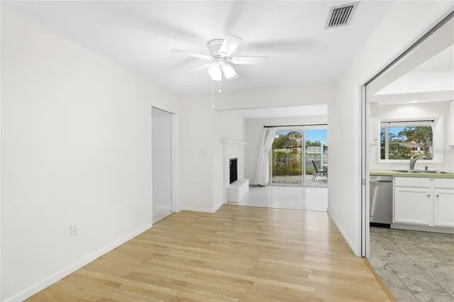 a view of a hallway with wooden floor and chandelier