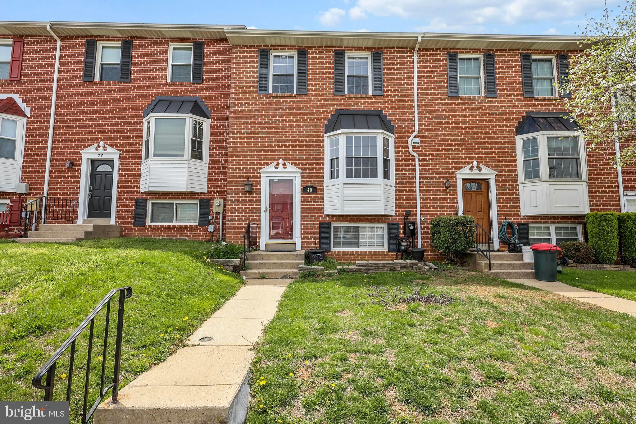 front view of a brick house with a yard