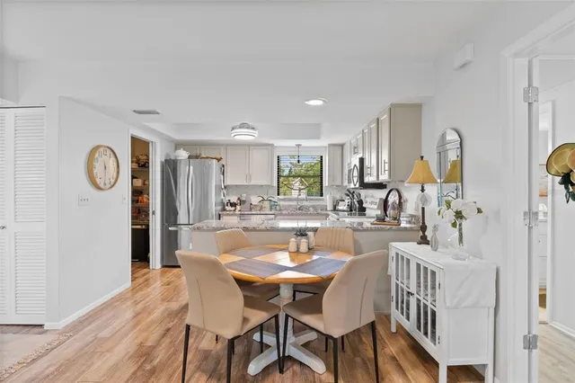 a view of a dining room with furniture and wooden floor