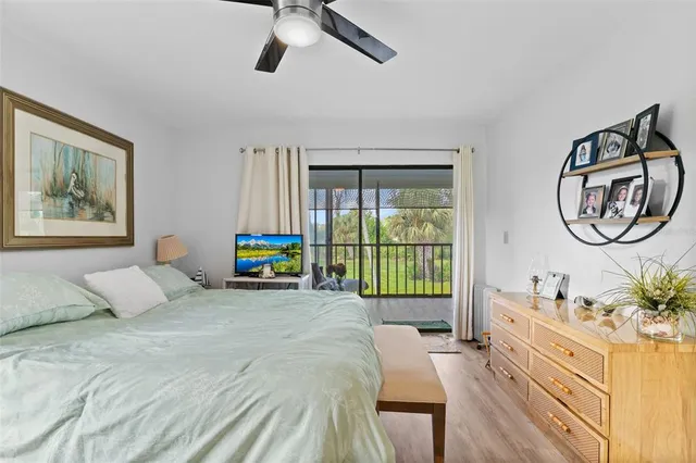 a bedroom with a bed mirror and window