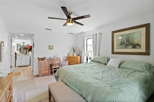 a bedroom with a bed a window and a chandelier