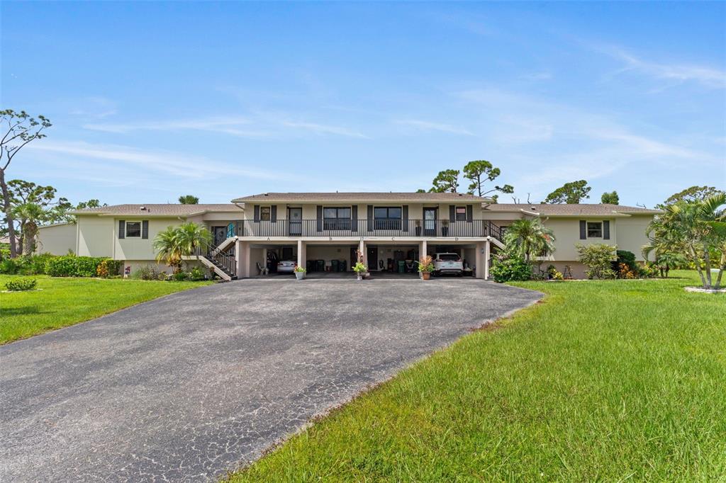 4260 Placida Road, Unit 17A Englewood, FL 34224 - Photo 2 of 34 a view of a house with a yard and potted plants