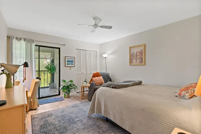 a bedroom with bed and glass door