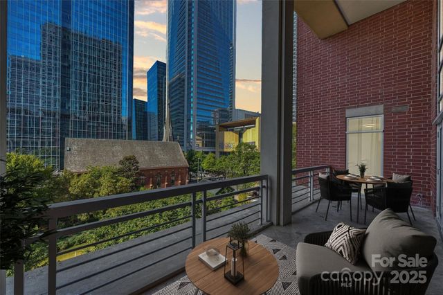 a balcony with chairs and a table