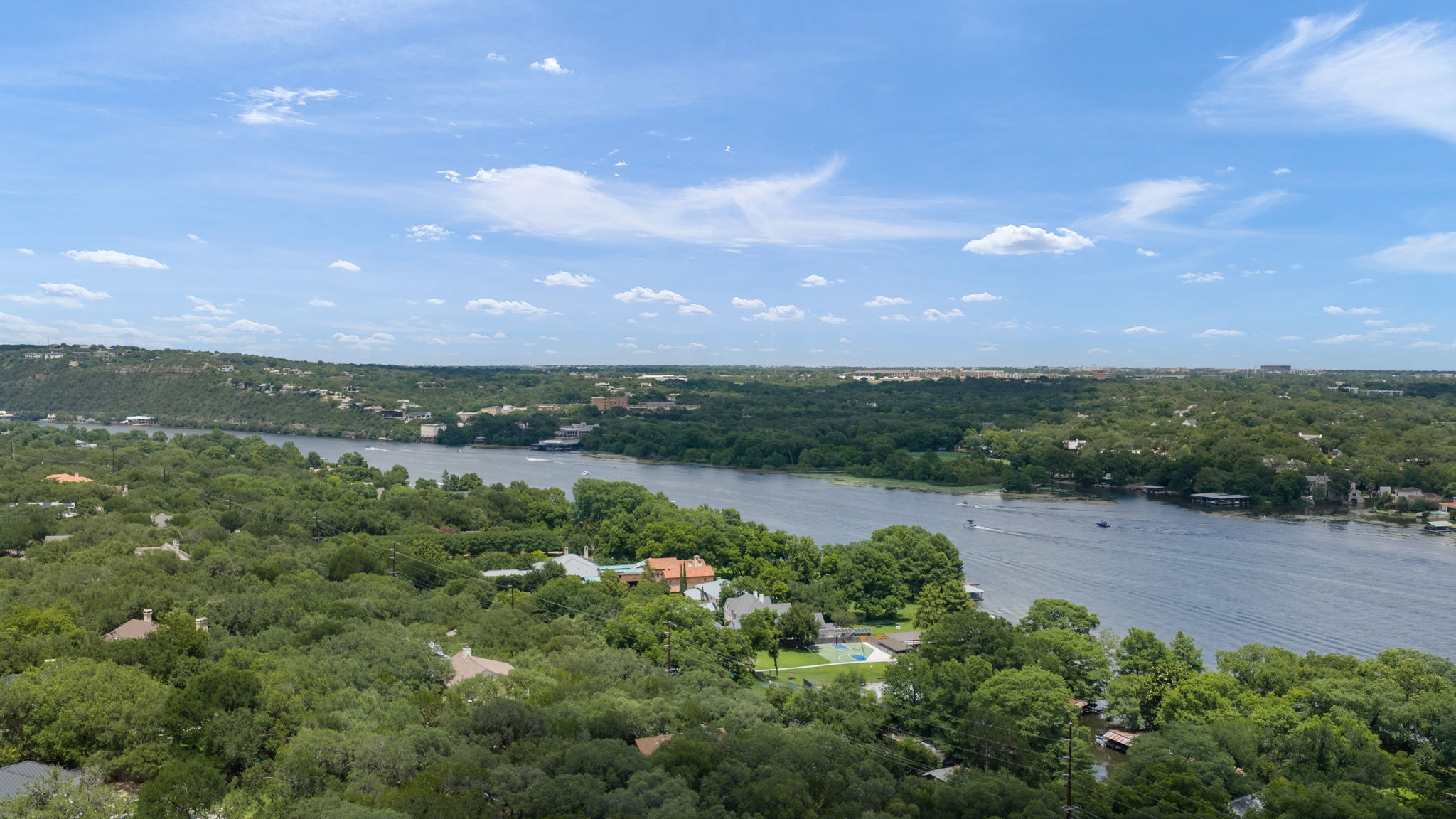 1910 Rue De St Tropez, Unit 6 Austin, TX 78746 - Photo 36 of 37 Perched above a winding river, this expansive landscape provides panoramic views of surrounding lush forests and distant horizons.