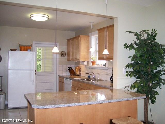 4012 Dover Road Jacksonville, FL 32207 - Photo 7 of 20 a view of a kitchen with kitchen island a counter top space and a potted plant