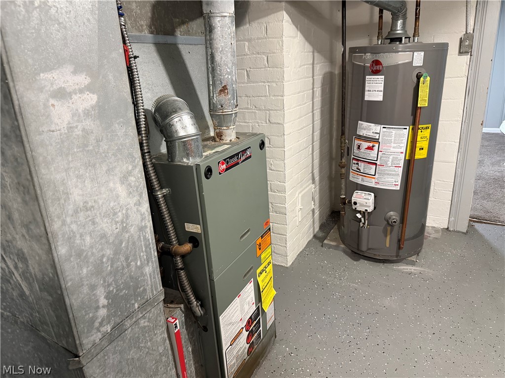 3714 Avalon Road Shaker Heights, OH 44120 - Photo 39 of 46 Dedicated utility area featuring a Rheem Classic Series furnace, a Rheem water heater, exposed ductwork, and brick-patterned walls, all set on a speckled epoxy floor