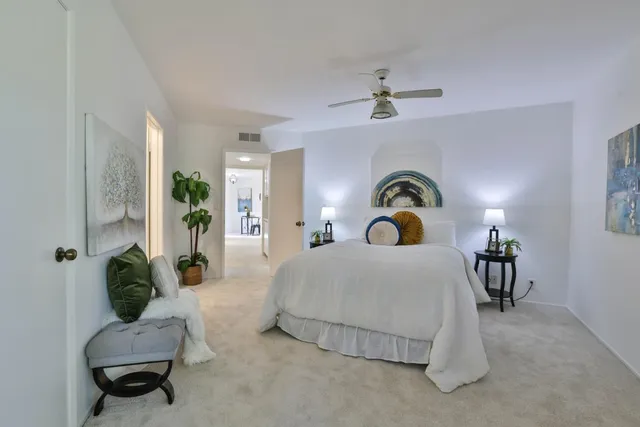 a bedroom with a bed couch and a window