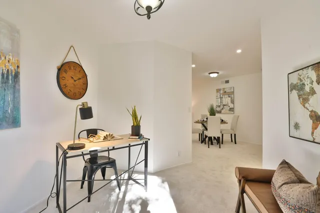a view of a dining room with furniture and chandelier