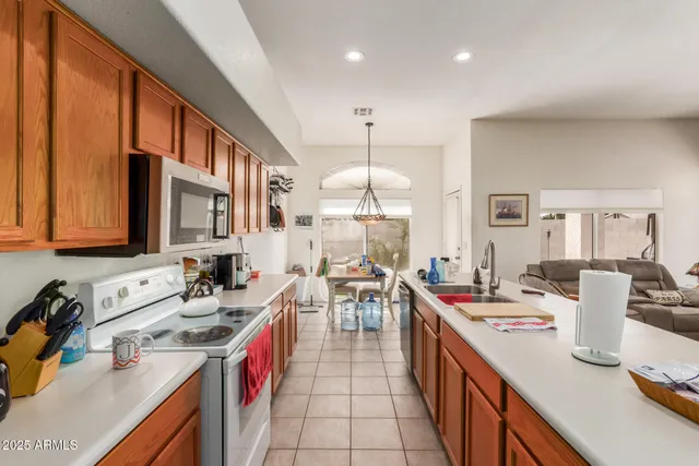 a kitchen with a sink stove and wooden cabinets