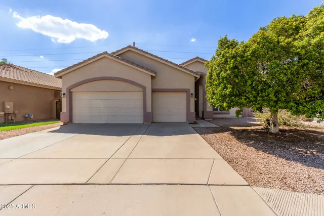 a view of a parking space in front of a house
