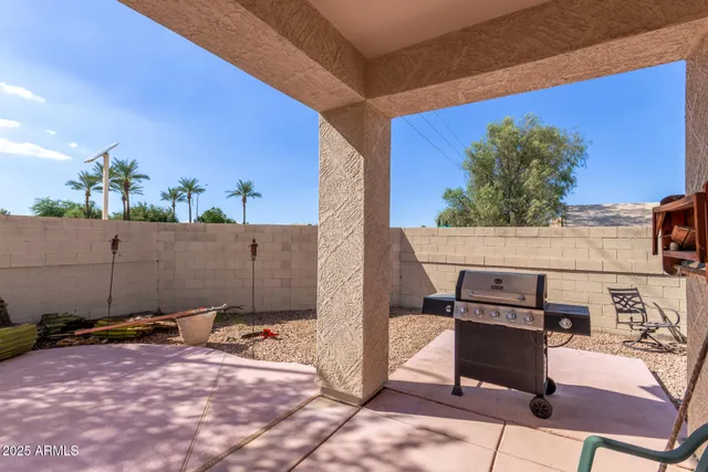 a view of a house with backyard and sitting area