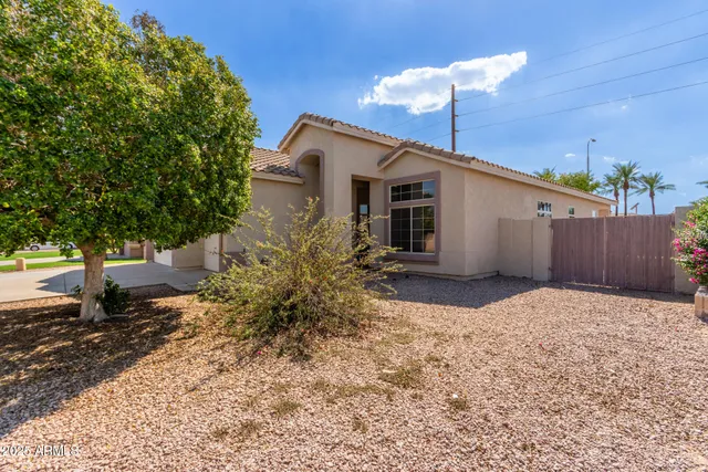 a backyard of a house with table and chairs