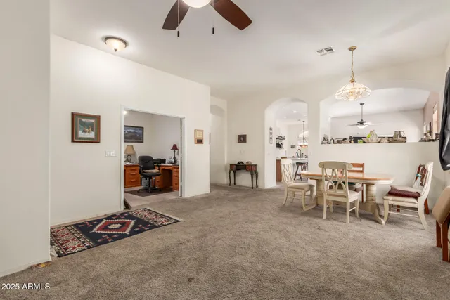 a view of a livingroom with furniture and a ceiling fan