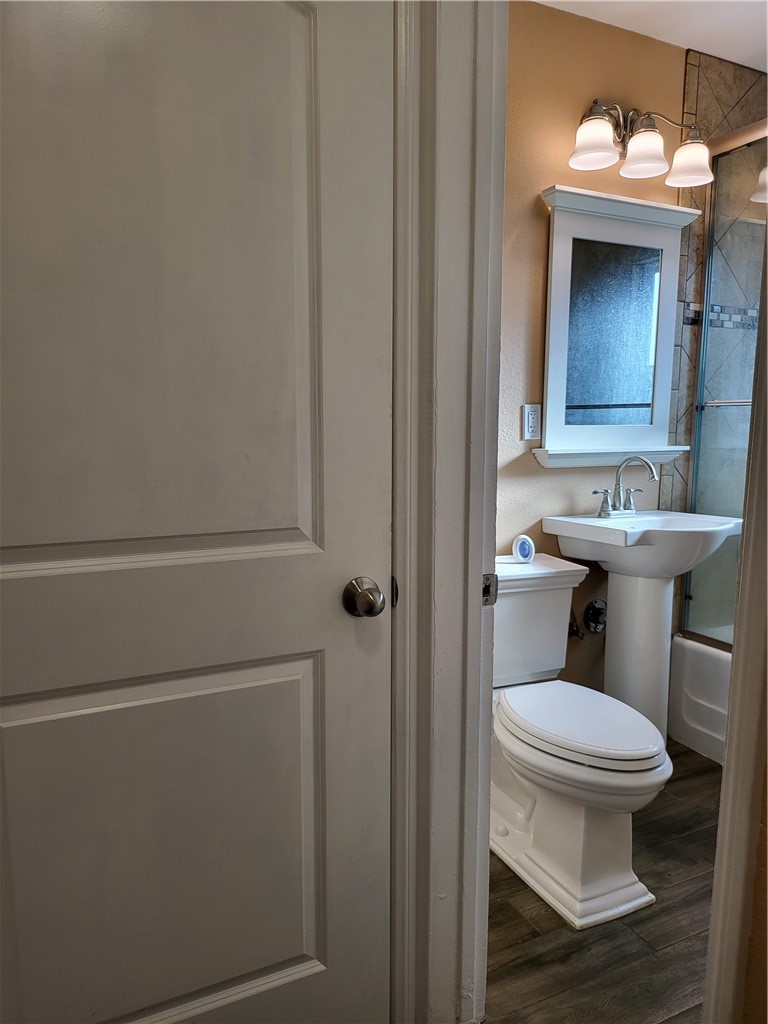 6636 Granger Avenue Bell Gardens, CA 90201 - Photo 10 of 11 a bathroom with a toilet a sink and mirror