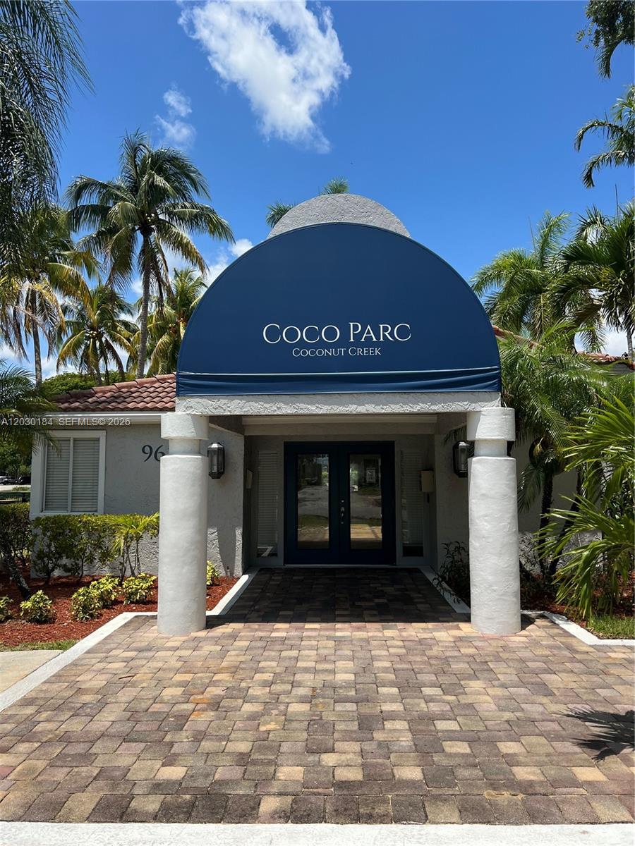 951 Lyons Road, Unit 6104 Coconut Creek, FL 33063 - Photo 16 of 18 a view of a house with a yard