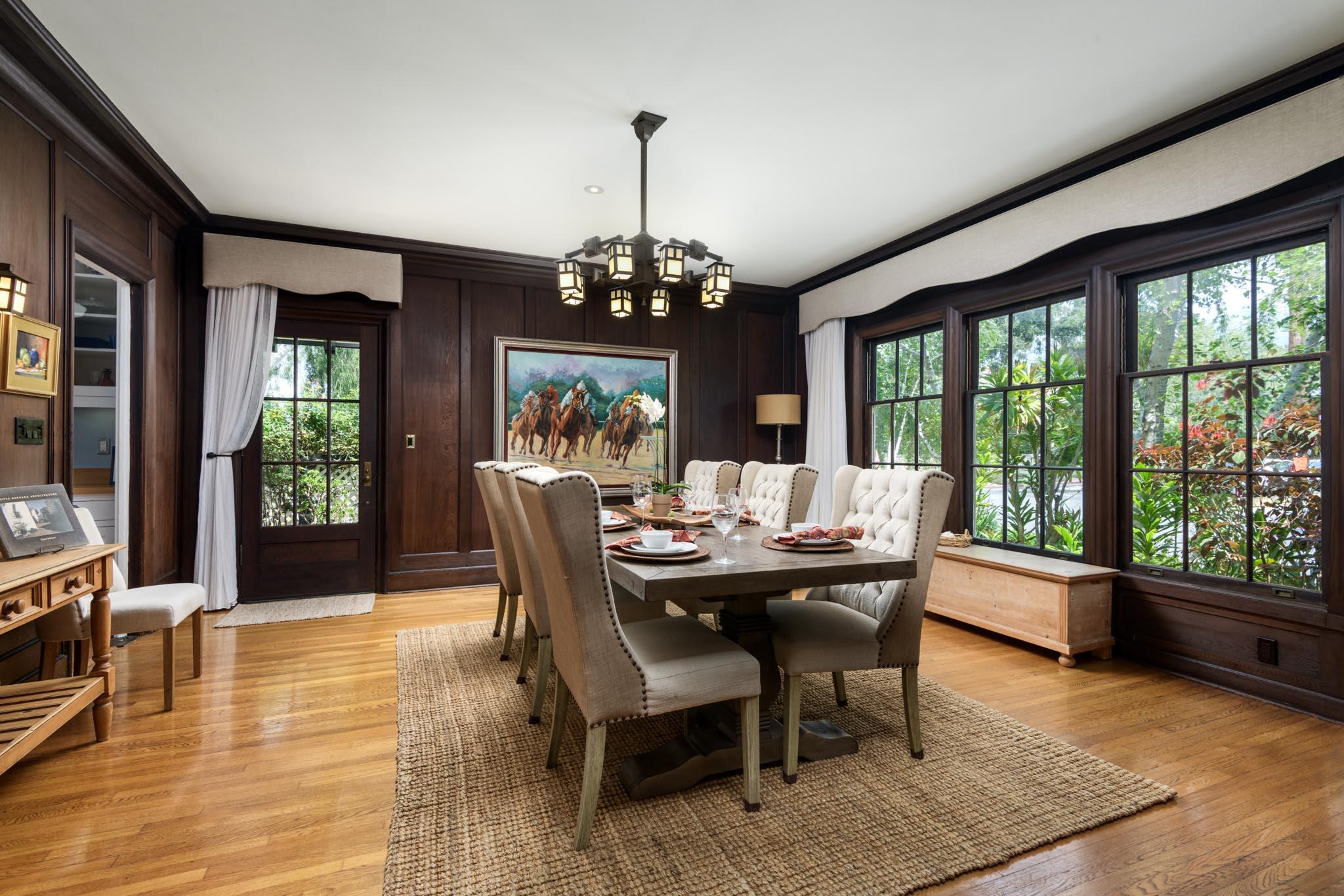 1833 Santa Barbara Street Santa Barbara, CA 93101 - Photo 11 of 35 a dining room with furniture a chandelier and wooden floor