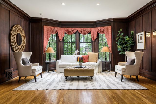 a living room with patio furniture and a potted plant