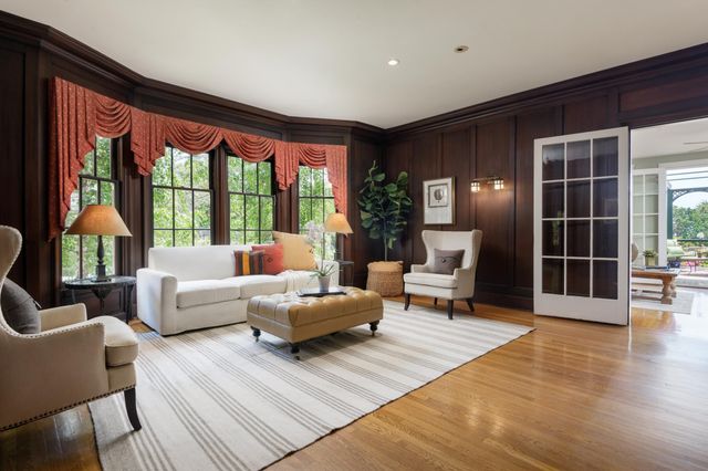 a dining room with furniture a chandelier and wooden floor