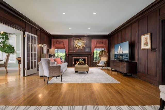 a bedroom with a bed a table and chair with a bookshelf