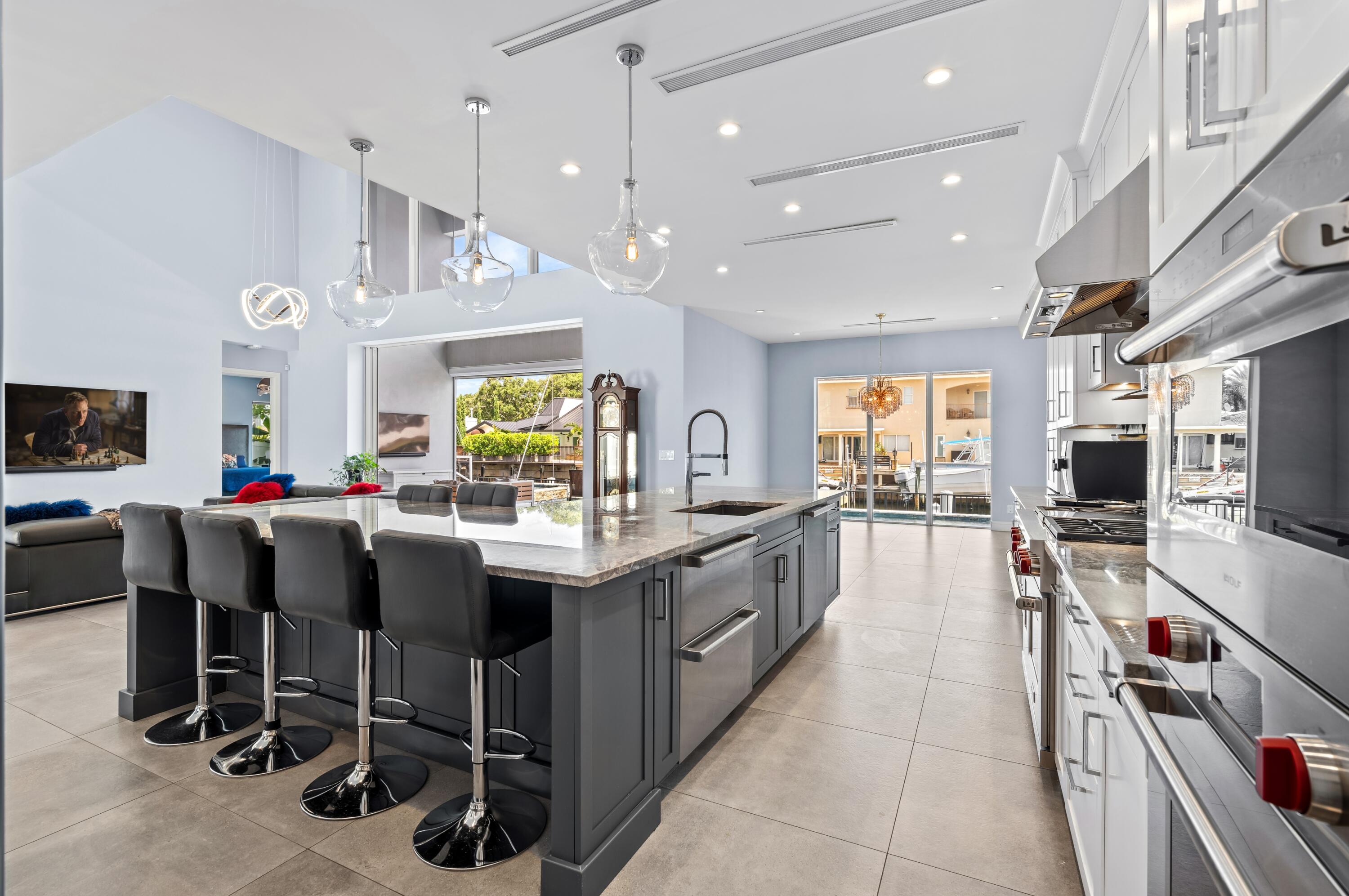 807 Dover Street Boca Raton, FL 33487 - Photo 7 of 47 a kitchen with kitchen island granite countertop a large center island and a sink