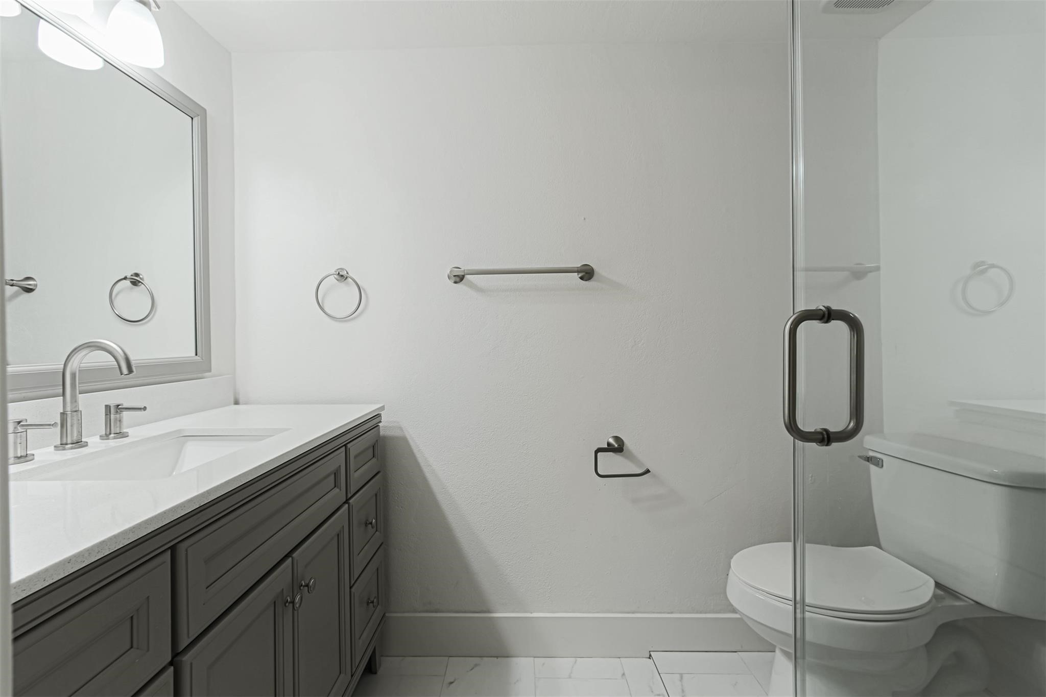 1255 Blalock Road, Unit 9 Houston, TX 77055 - Photo 14 of 15 a bathroom with a toilet sink and mirror