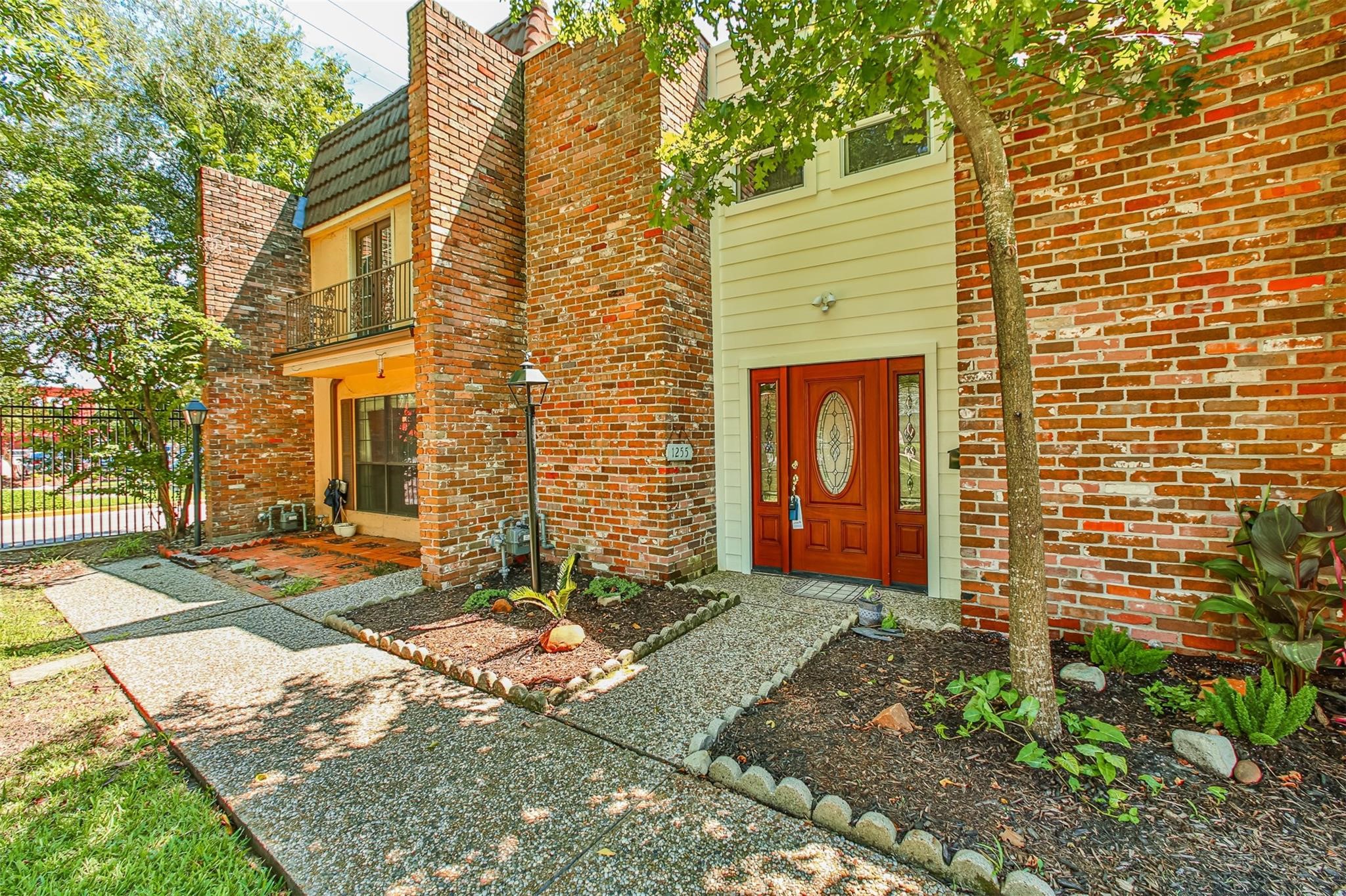 1255 Blalock Road, Unit 9 Houston, TX 77055 - Photo 2 of 15 a front view of a house with garden