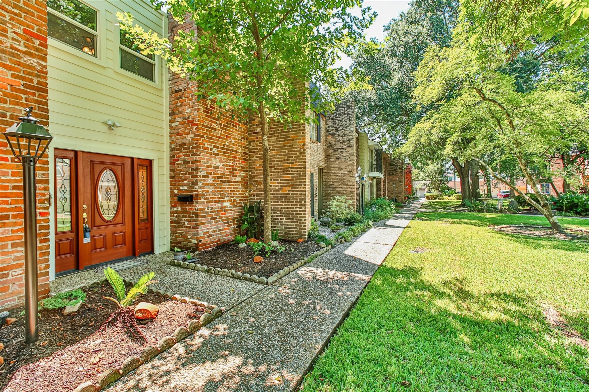 1255 Blalock Road, Unit 9 Houston, TX 77055 - Photo 3 of 15 a brick building with a tree in front of it