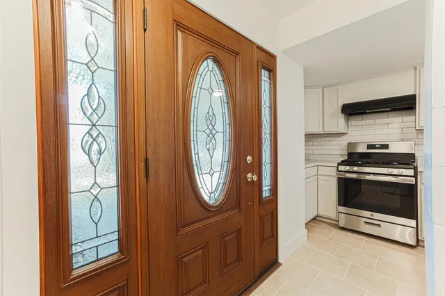 a view of a kitchen with stainless steel appliances granite countertop a refrigerator and a stove top oven