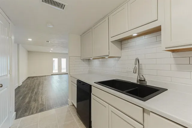 a kitchen with a sink and cabinets