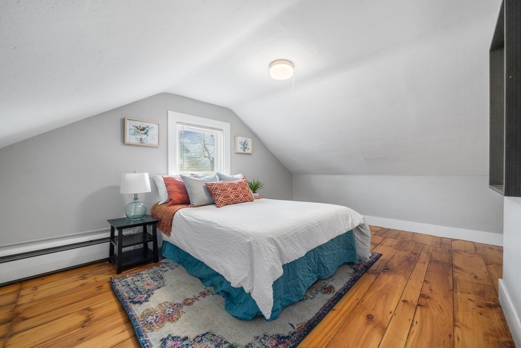 81 West Main Street Merrimac, MA 01860 - Photo 23 of 28 a bedroom with a bed and wooden floor