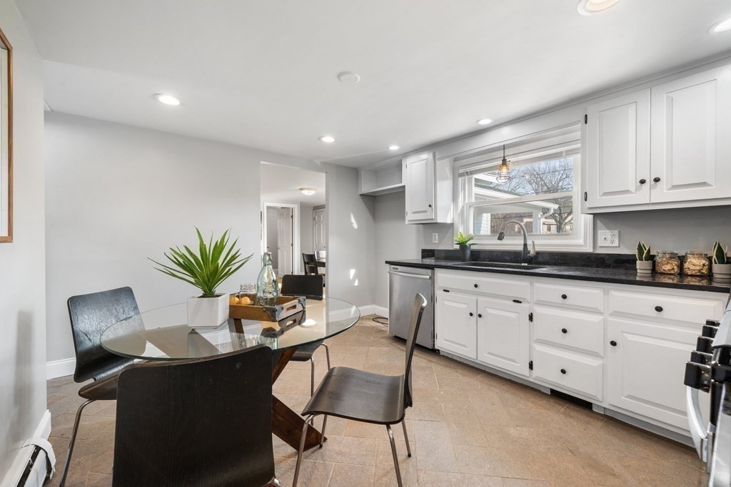 81 West Main Street Merrimac, MA 01860 - Photo 10 of 28 a kitchen with granite countertop white cabinets and chairs