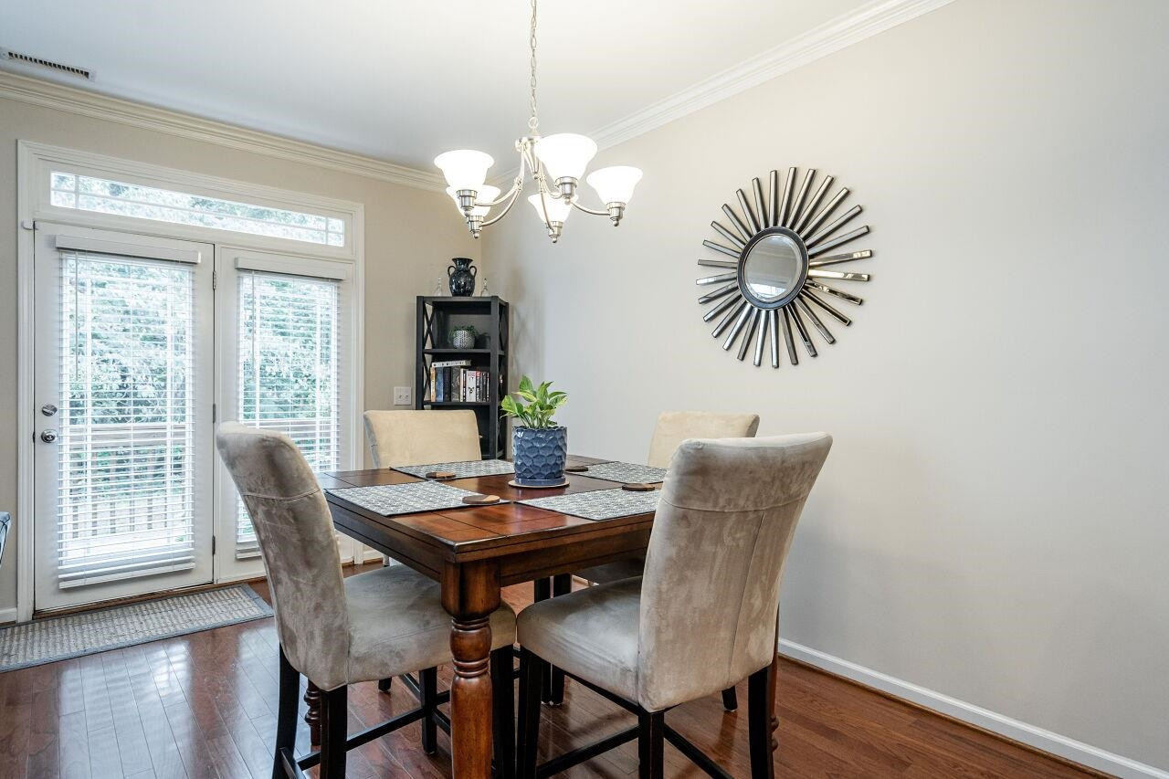 4638 Altha Street Raleigh, NC 27606 - Photo 8 of 27 a view of a dining room with furniture wooden floor and chandelier