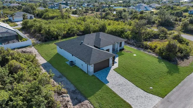 a aerial view of a house with a yard